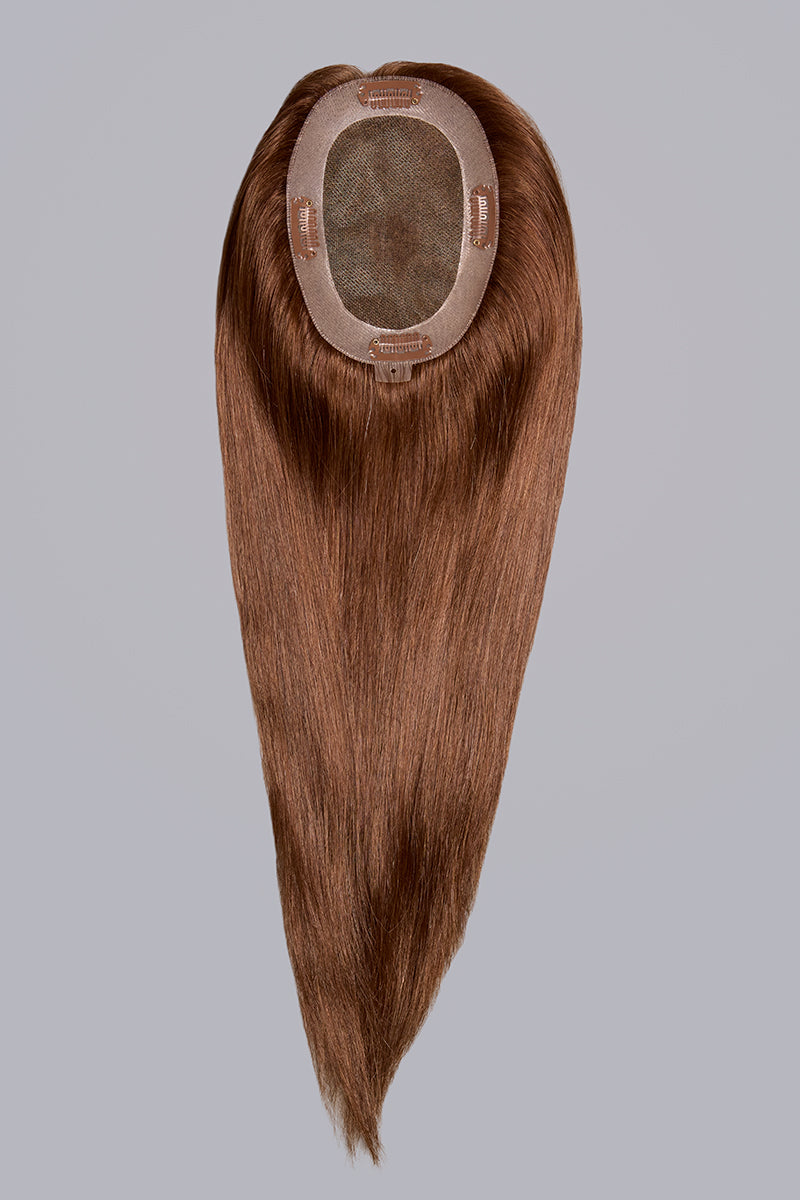 Brown hair extension on a gray background