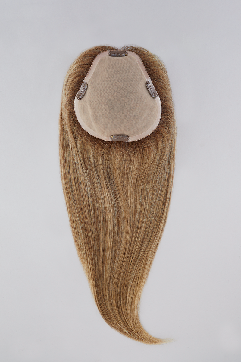 Blonde hair extension with beige clip on a white background